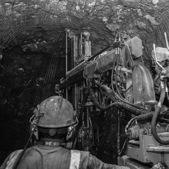 A man using machinery in a mine